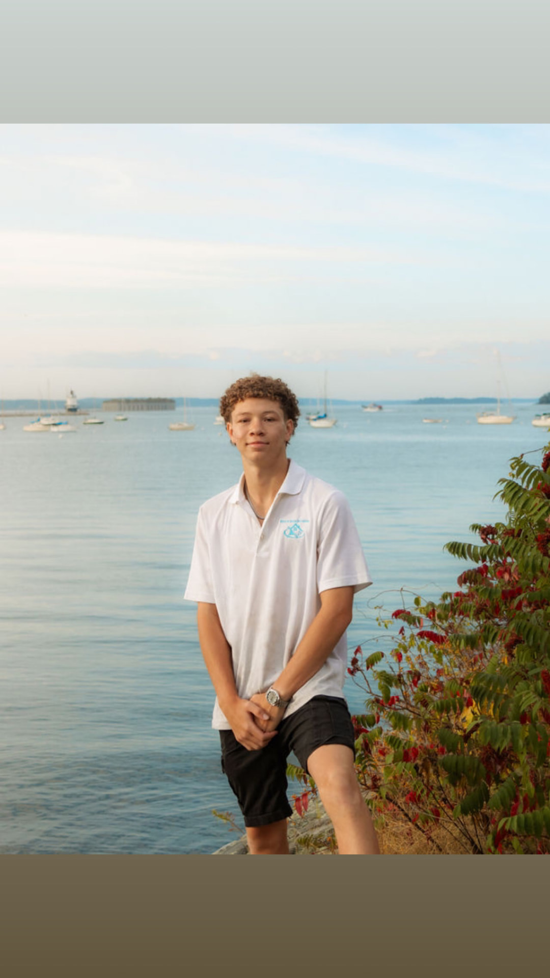 Jayden Ross, owner of Rise N Shine Window Cleaning, standing by the Maine coast